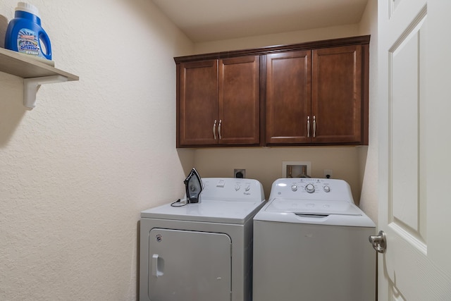 29 Mediterranean Blvd W, Port Saint Lucie, FL 34952 - laundry area featuring cabinet space, washing machine and clothes dryer, and a textured wall