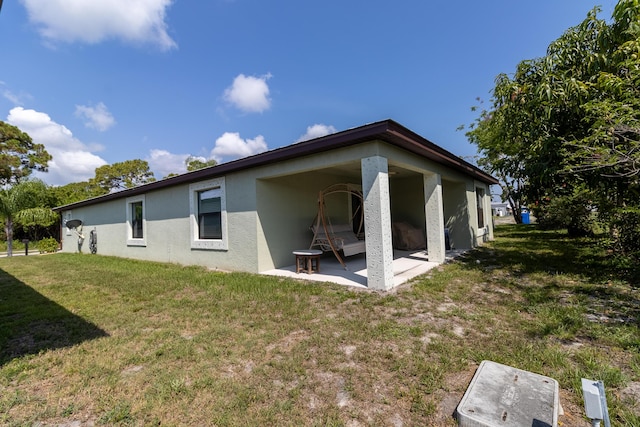 29 Mediterranean Blvd W, Port Saint Lucie, FL 34952 - rear view of property with stucco siding, a patio, and a lawn