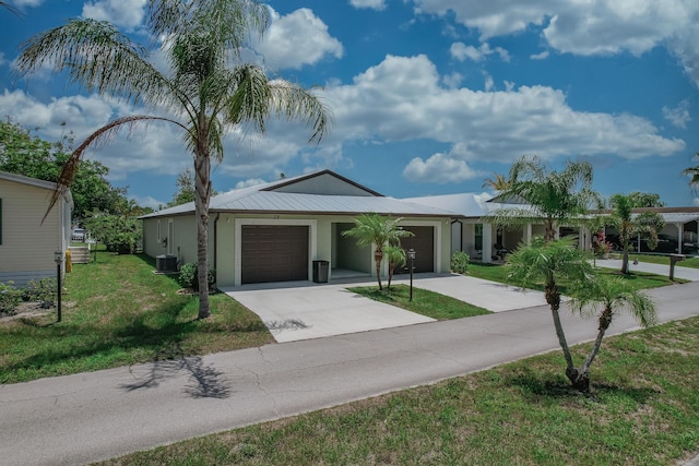 29 Mediterranean Blvd W, Port Saint Lucie, FL 34952 - single story home with a garage, a front yard, driveway, stucco siding, and central AC unit