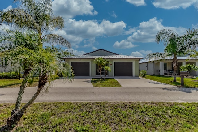 29 Mediterranean Blvd W, Port Saint Lucie, FL 34952 - single story home featuring driveway, a standing seam roof, an attached garage, stucco siding, and metal roof