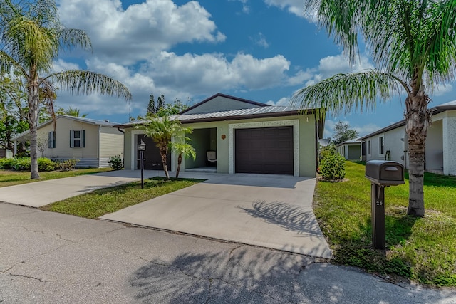 29 Mediterranean Blvd W, Port Saint Lucie, FL 34952 - single story home featuring driveway, an attached garage, a front lawn, stucco siding, and metal roof