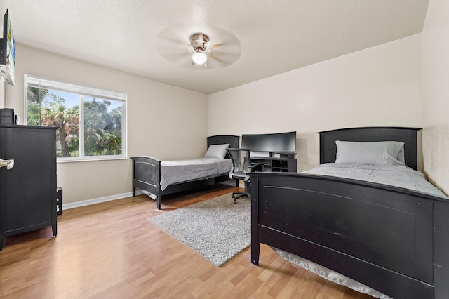 6839 Banyan Blvd, The Acreage, FL 33470 - bedroom with light wood-style flooring, baseboards, and ceiling fan