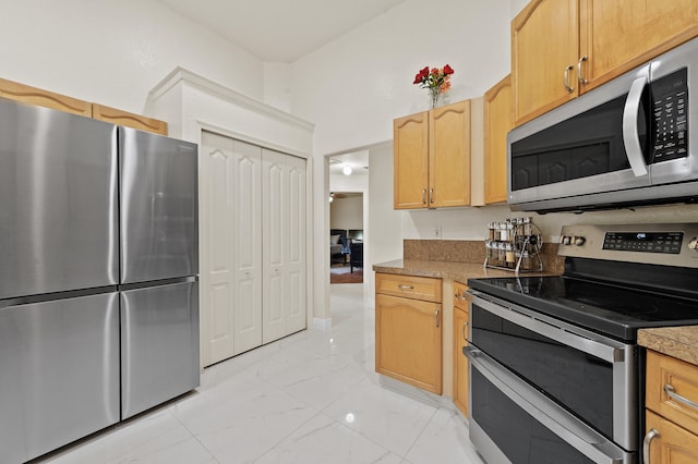 6839 Banyan Blvd, The Acreage, FL 33470 - kitchen with appliances with stainless steel finishes, light marble finish flooring, and light brown cabinetry