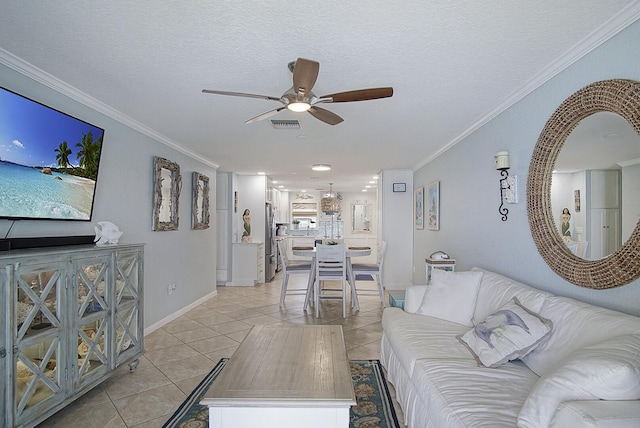1177 Bayshore Dr Unit 207, Fort Pierce, FL 34949 - living area with a ceiling fan, light tile patterned floors, crown molding, baseboards, and a textured ceiling