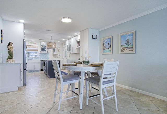 1177 Bayshore Dr Unit 207, Fort Pierce, FL 34949 - dining room with light tile patterned floors, crown molding, a chandelier, baseboards, and recessed lighting