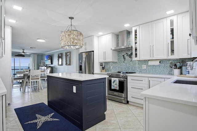 1177 Bayshore Dr Unit 207, Fort Pierce, FL 34949 - kitchen featuring stainless steel appliances, wall chimney range hood, a sink, light tile patterned flooring, and backsplash