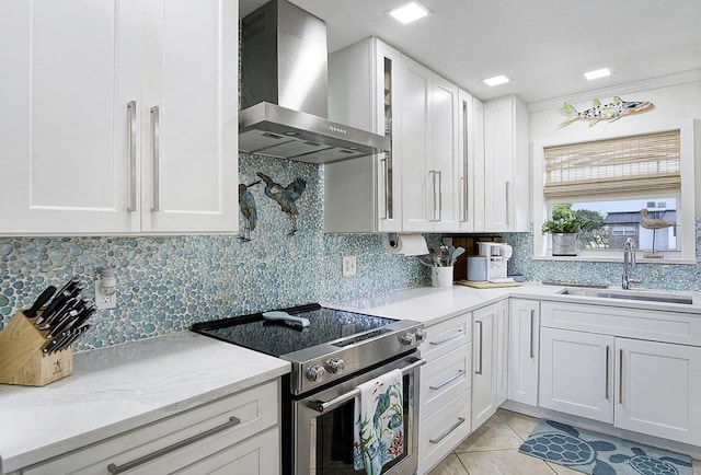 1177 Bayshore Dr Unit 207, Fort Pierce, FL 34949 - kitchen featuring wall chimney exhaust hood, electric stove, a sink, and white cabinetry