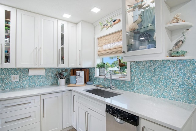 1177 Bayshore Dr Unit 207, Fort Pierce, FL 34949 - kitchen with stainless steel dishwasher, a sink, white cabinets, and light countertops