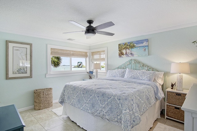 1177 Bayshore Dr Unit 207, Fort Pierce, FL 34949 - bedroom with crown molding, light tile patterned floors, ceiling fan, a textured ceiling, and baseboards