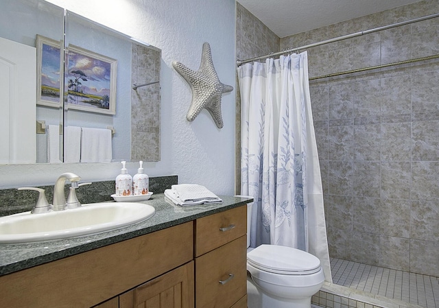 1177 Bayshore Dr Unit 207, Fort Pierce, FL 34949 - bathroom with a textured wall, vanity, toilet, and a tile shower