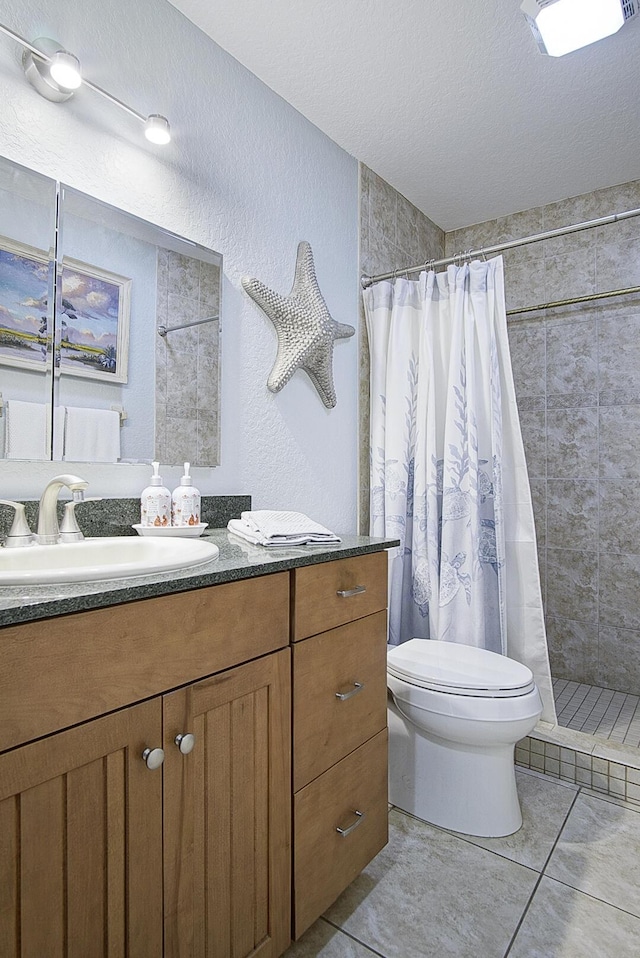 1177 Bayshore Dr Unit 207, Fort Pierce, FL 34949 - full bath featuring toilet, vanity, a tile shower, tile patterned flooring, and a textured ceiling