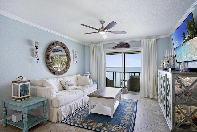 1177 Bayshore Dr Unit 207, Fort Pierce, FL 34949 - living room featuring ceiling fan, crown molding, a textured ceiling, and light tile patterned flooring