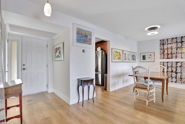 2850 Carambola Cir S Unit 19121, Coconut Creek, FL 33066 - dining space featuring light wood-type flooring, baseboards, and a textured ceiling