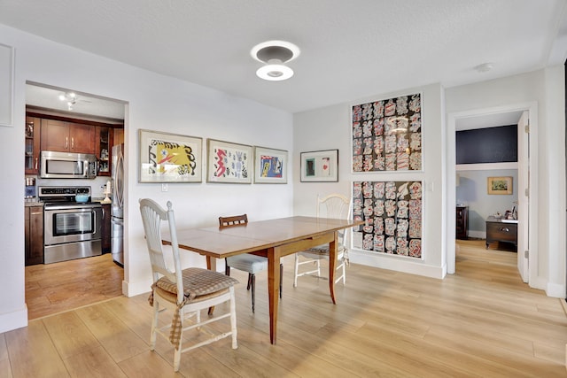 2850 Carambola Cir S Unit 19121, Coconut Creek, FL 33066 - dining area with light wood-style flooring and baseboards