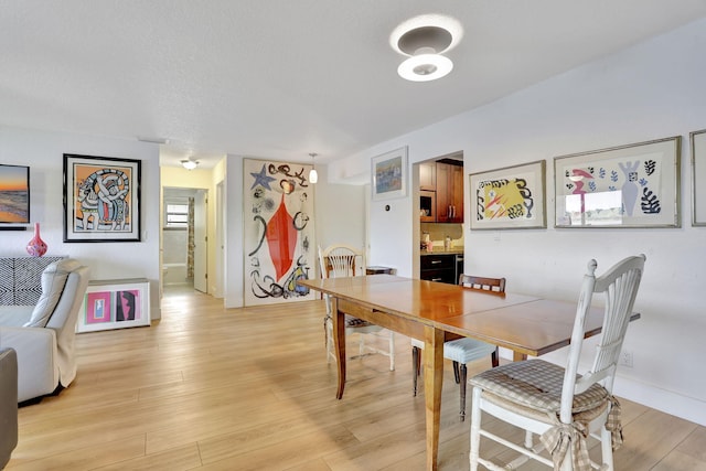 2850 Carambola Cir S Unit 19121, Coconut Creek, FL 33066 - dining area with light wood-type flooring and baseboards