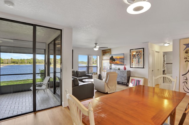 2850 Carambola Cir S Unit 19121, Coconut Creek, FL 33066 - dining room with ceiling fan, a textured ceiling, and light wood-style floors