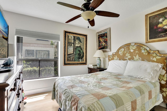 2850 Carambola Cir S Unit 19121, Coconut Creek, FL 33066 - bedroom with wood finished floors, ceiling fan, and a textured ceiling