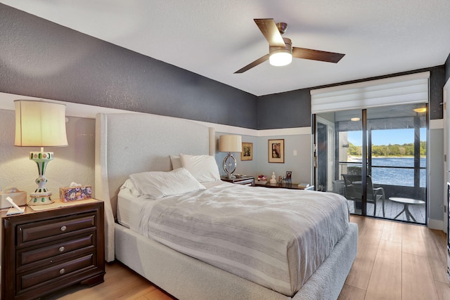2850 Carambola Cir S Unit 19121, Coconut Creek, FL 33066 - bedroom featuring access to outside, light wood-style flooring, and a ceiling fan