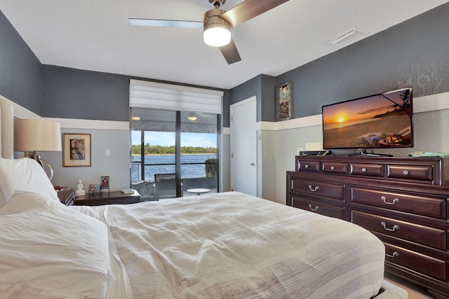 2850 Carambola Cir S Unit 19121, Coconut Creek, FL 33066 - bedroom with access to exterior and a ceiling fan