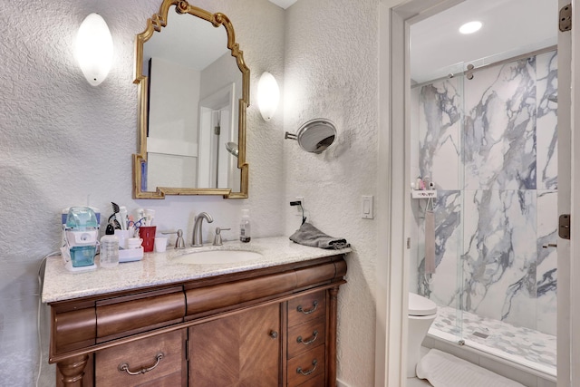 2850 Carambola Cir S Unit 19121, Coconut Creek, FL 33066 - full bathroom featuring a marble finish shower, a textured wall, vanity, and toilet