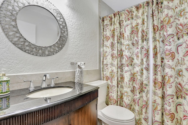 2850 Carambola Cir S Unit 19121, Coconut Creek, FL 33066 - bathroom featuring a textured wall, vanity, tile walls, toilet, and a shower with shower curtain