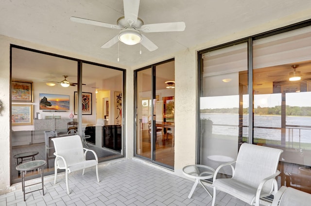 2850 Carambola Cir S Unit 19121, Coconut Creek, FL 33066 - sunroom with a ceiling fan, a water view, and healthy amount of natural light