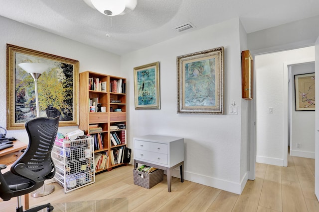 2850 Carambola Cir S Unit 19121, Coconut Creek, FL 33066 - office space featuring light wood-type flooring, baseboards, and a textured ceiling