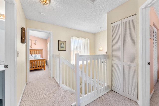 7930 Nolting Ct, Lake Worth, FL 33467 - hallway with carpet floors, an upstairs landing, a textured ceiling, and baseboards