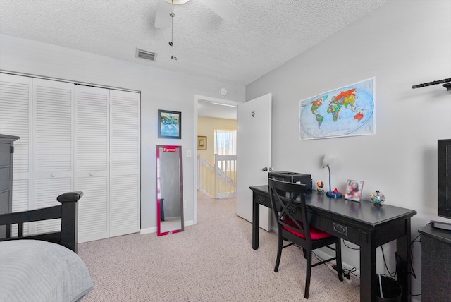 7930 Nolting Ct, Lake Worth, FL 33467 - bedroom with light carpet, a closet, a textured ceiling, baseboards, and a ceiling fan