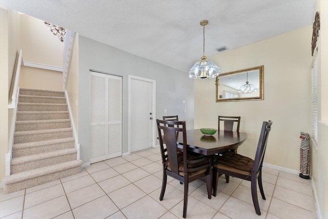 7930 Nolting Ct, Lake Worth, FL 33467 - dining room with stairs, light tile patterned floors, a chandelier, baseboards, and a textured ceiling