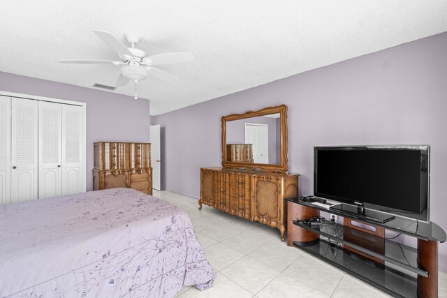 4731 Storkwood Ln Unit A, Boynton Beach, FL 33436 - bedroom with a closet, light tile patterned flooring, a ceiling fan, and a textured ceiling