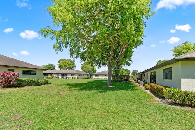 4731 Storkwood Ln Unit A, Boynton Beach, FL 33436 - view of green lawn with central air condition unit