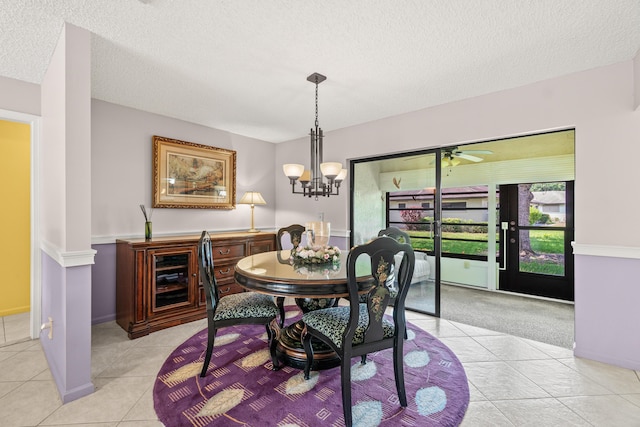4731 Storkwood Ln Unit A, Boynton Beach, FL 33436 - dining space with light tile patterned floors, a textured ceiling, a ceiling fan, and a chandelier