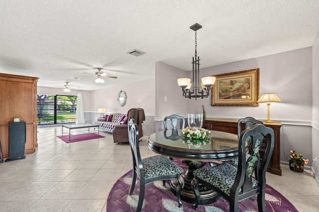 4731 Storkwood Ln Unit A, Boynton Beach, FL 33436 - dining area featuring a textured ceiling, light tile patterned floors, a ceiling fan, and a chandelier