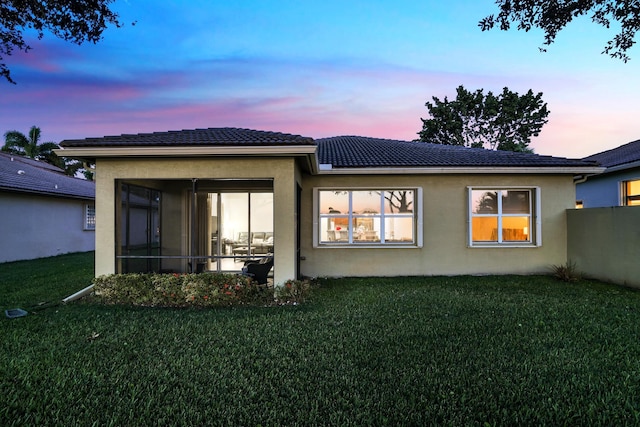 14841 Strand Ln (), Unit Delray Beach, FL 33446 - rear view of house with stucco siding, a yard, a sunroom, and a tile roof