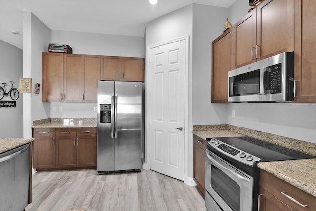 14841 Strand Ln (), Unit Delray Beach, FL 33446 - kitchen featuring stainless steel appliances, light wood-style floors, and light stone countertops
