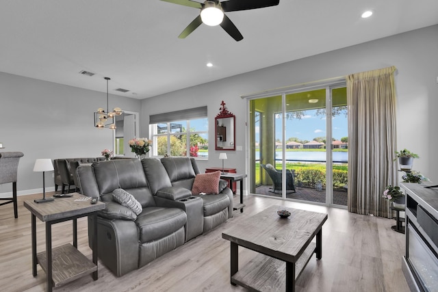 14841 Strand Ln (), Unit Delray Beach, FL 33446 - living area with light wood finished floors, a ceiling fan, a chandelier, a water view, and recessed lighting