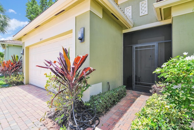 14841 Strand Ln (), Unit Delray Beach, FL 33446 - entrance to property featuring stucco siding and a garage
