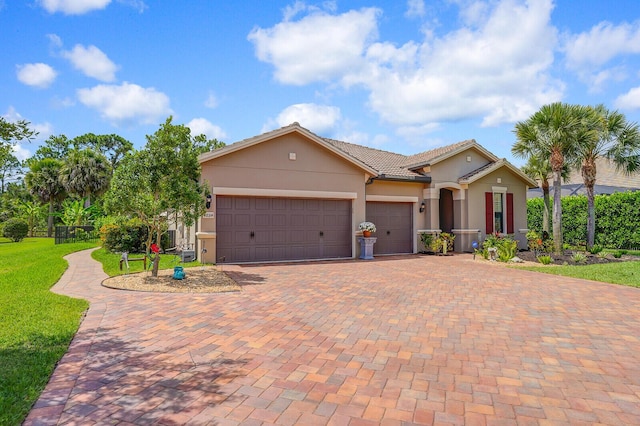 4884 SW Gossamer Cir, Palm City, FL 34990 - view of front of property with a garage, decorative driveway, a tiled roof, stucco siding, and a front lawn