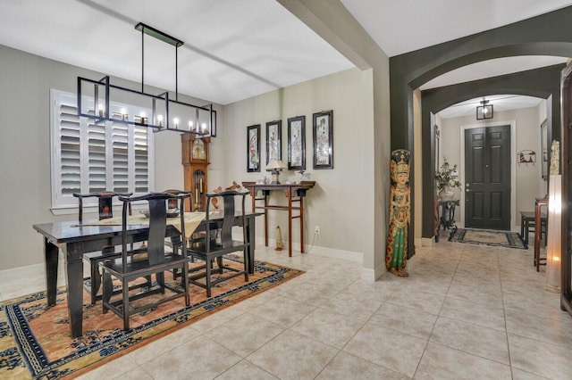 4884 SW Gossamer Cir, Palm City, FL 34990 - tiled dining space with arched walkways, a chandelier, and baseboards