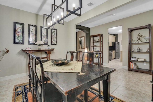 4884 SW Gossamer Cir, Palm City, FL 34990 - dining area with arched walkways, light tile patterned flooring, and baseboards