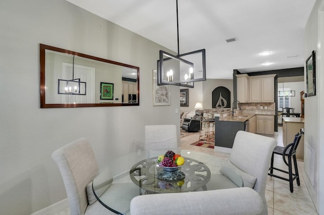 4884 SW Gossamer Cir, Palm City, FL 34990 - dining area with a chandelier, baseboards, and light tile patterned floors