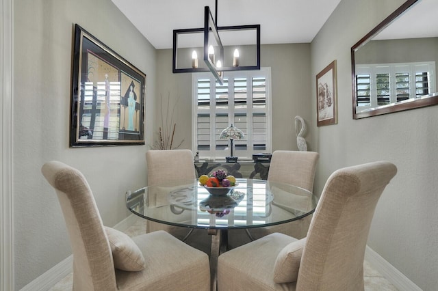 4884 SW Gossamer Cir, Palm City, FL 34990 - dining space with a chandelier and baseboards