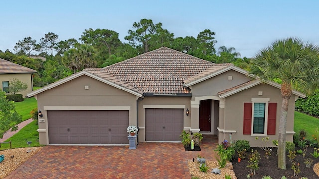 4884 SW Gossamer Cir, Palm City, FL 34990 - view of front of home with an attached garage, stucco siding, driveway, and a tiled roof