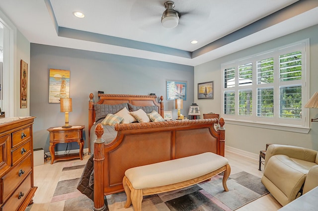 4884 SW Gossamer Cir, Palm City, FL 34990 - bedroom with recessed lighting, a raised ceiling, light wood-style floors, baseboards, and a ceiling fan