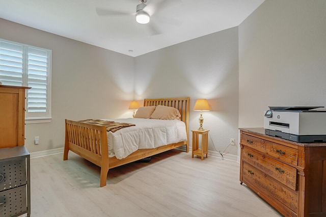 4884 SW Gossamer Cir, Palm City, FL 34990 - bedroom with light wood finished floors, baseboards, and ceiling fan