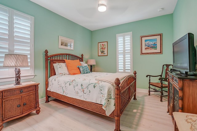 4884 SW Gossamer Cir, Palm City, FL 34990 - bedroom with light wood-style floors, baseboards, and a ceiling fan