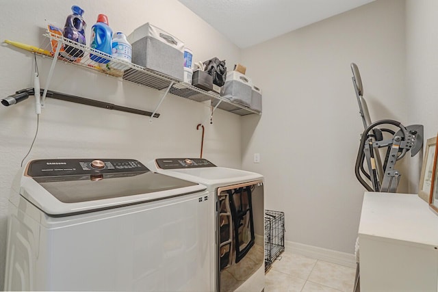 4884 SW Gossamer Cir, Palm City, FL 34990 - laundry room featuring separate washer and dryer, light tile patterned floors, and baseboards