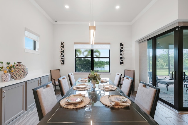 11620 Sally Ann Dr, Palm Beach Gardens, FL 33412 - dining room with ornamental molding, light wood-style floors, and recessed lighting