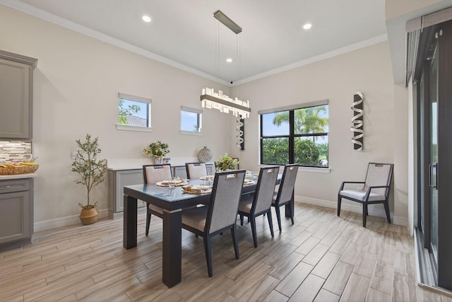 11620 Sally Ann Dr, Palm Beach Gardens, FL 33412 - dining room with healthy amount of natural light, light wood-style floors, baseboards, recessed lighting, and crown molding